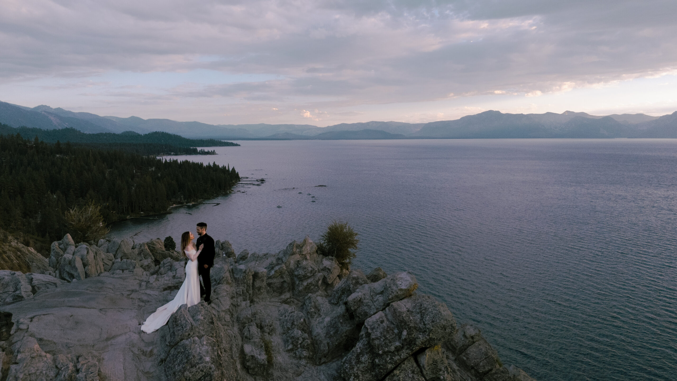 Images of bride and groom on a mountain in South Lake Tahoe for their wedding phootos. Emotional images with beautiful landscape. Drone wedding photos
